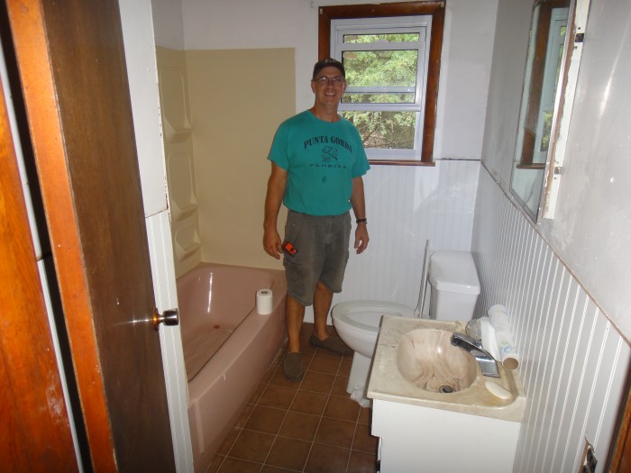 The bathroom with the original pink tub